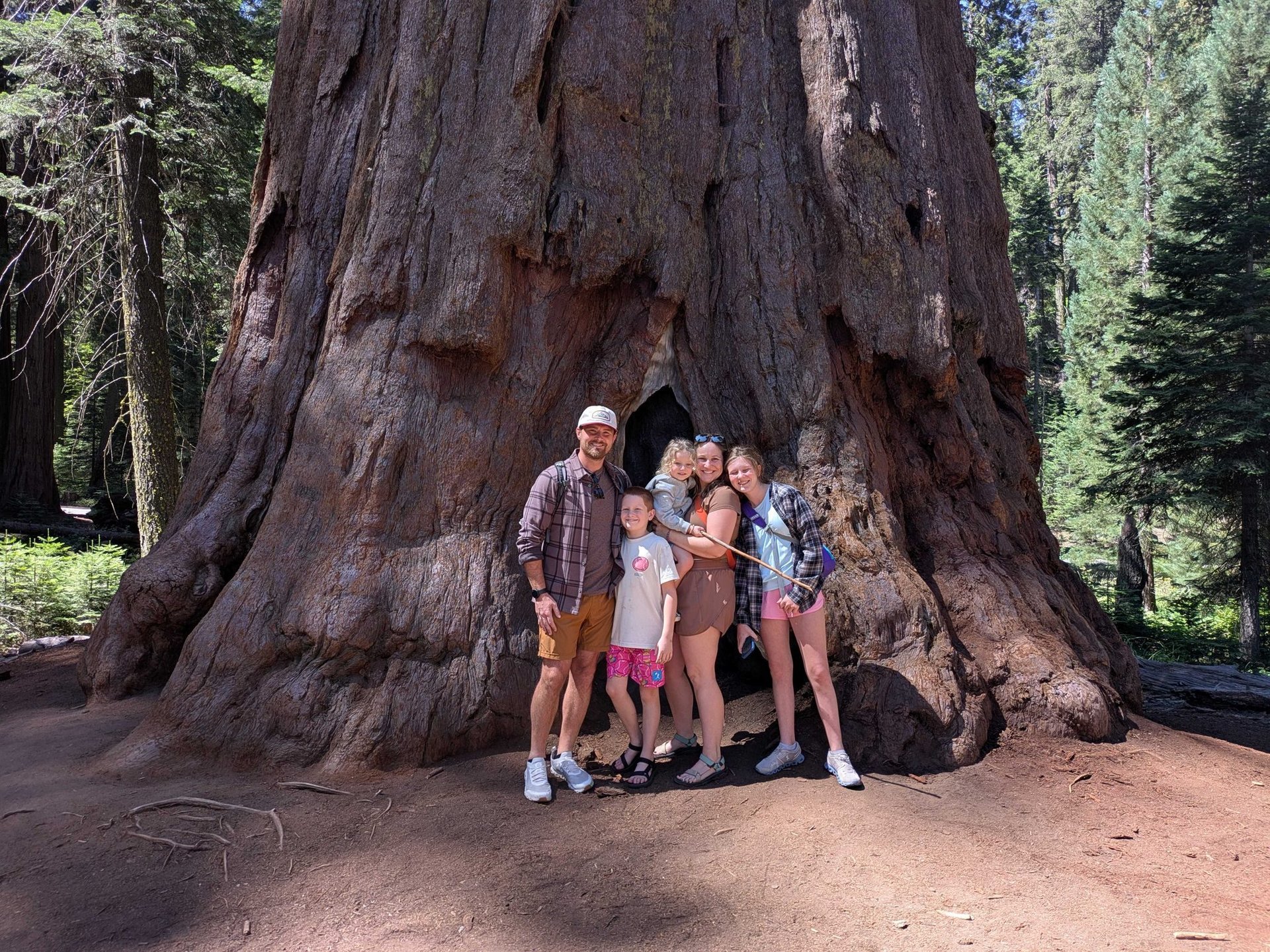 Christian Hyatt and family in front of a redwood tree